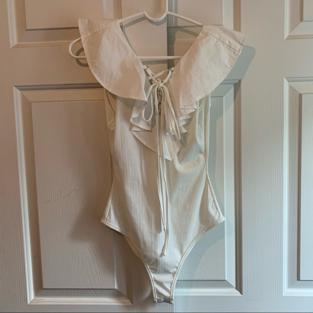 White lace up ribbed bodysuit with ruffle shoulder